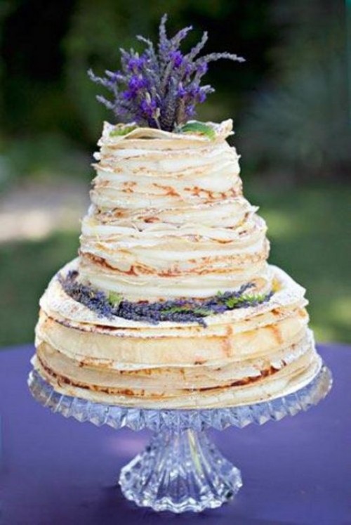 a crepe wedding cake topped with lavender and with cream between tiers is a gorgeous idea for any wedding
