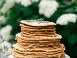 a pancake wedding cake with cream and some lavender on top is a lovely idea for a modern and relaxed wedding, in spring and summer