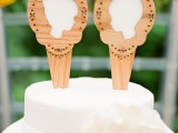 a white wedding cake topped with wooden silhouettes is a cool and lovely idea for a rustic wedding, you can make them yourself