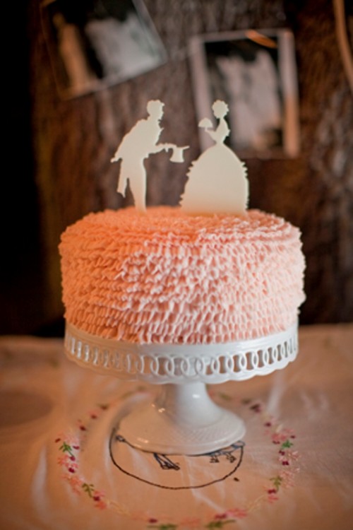 a pink textural wedding cake with white chocolate silhouette cake toppers is a cute and lovely idea for a wedding