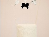 a white textural wedding cake with a bunting cake topper and a black silhouette addition is a fantastic idea for a wedding
