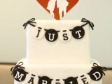 a white wedding cake with a black and white sugar bunting and a red and white silhouette cake topper is amazing for a wedding