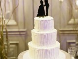 a textural white wedding cake topped with a black couple silhouette is a classic idea for a vintage wedding