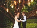 a living tree covered with lights as a lovely and all-natural backyard backdrop for a wedding