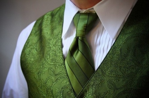 a white shirt, a patterned green waistcoat and a matching tie to express the personal style of the groom