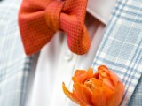 a light blue plaid blazer accented with an orange floral boutonniere and a matching bow tie for a contrast
