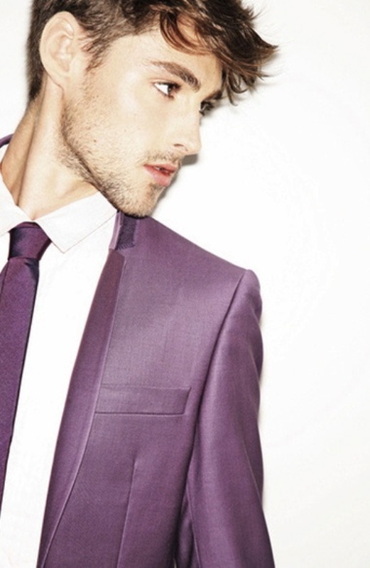 a purple suit, a white shirt and a purple tie for a stylish jewel toned groom's look