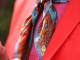 a hot red suit, a hot pink shirt and a bright printed necktie for a unique groom’s outfit