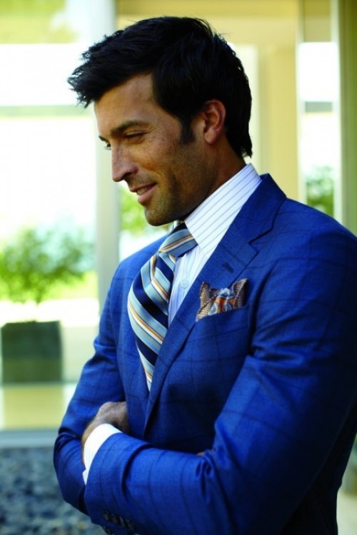 a bold blue suit, a striped shirt and a bright striped tie for a chic and bold groom's look