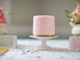 a pink polka dot mini cake with a copper stripe is a stylish and cool dessert for a glam wedding