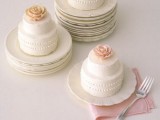 white individual wedding cakes with sugar patterns and pink sugar blooms on top are refined and delicious
