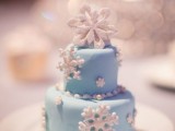 an individual blue wedding cake with white sugar snowflakes is amazing for a winter wonderland wedding