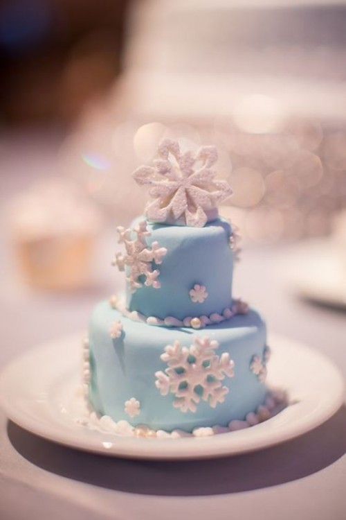 an individual blue wedding cake with white sugar snowflakes is amazing for a winter wonderland wedding