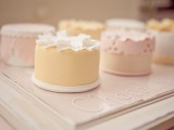 individual pastel wedding cakes decorated with sugar lace, beads, gold and ruffles