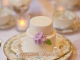a neutral individual wedding cake with edible beads, flowers and leaves and a tag is an amazing and delicious idea