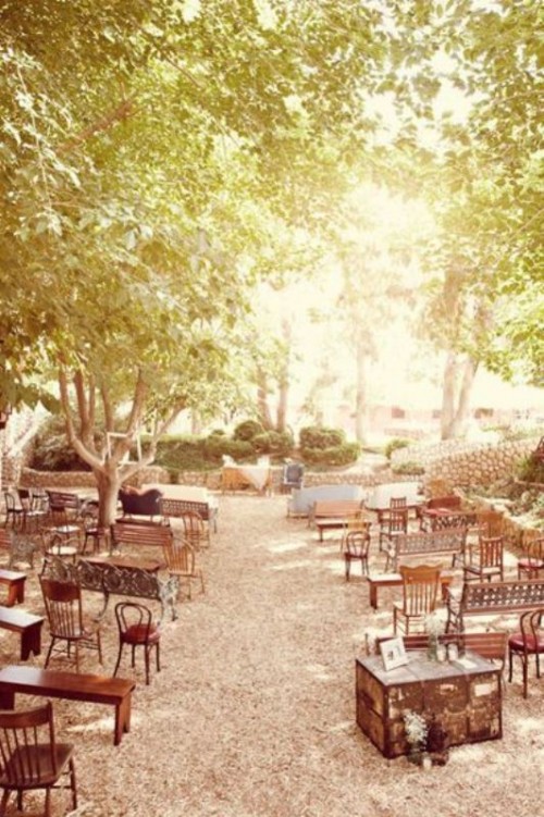 mismatching vintage chairs and benches create a proper feel for a shabby chic or vintage wedding ceremony
