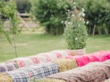 hay stacks covered with plaid and bold blankets will be a nice idea for a rustic wedding, they will add a real rustic feel to the ceremony space