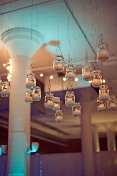 suspended mason jars with candles will illuminate various spaces of your wedding venue and will make it more welcoming and cozy