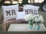 blue mason jars with white hydrangeas are great to decorate a rustic wedding, they can be centerpieces or just arrangement