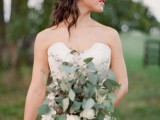 a seeded eucalyptus wedding bouquet with some white blooms is a cool and fresh option for a modern bride