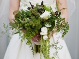 a textural greenery wedding bouquet with cascading touches, white blooms, some lotus and other stuff