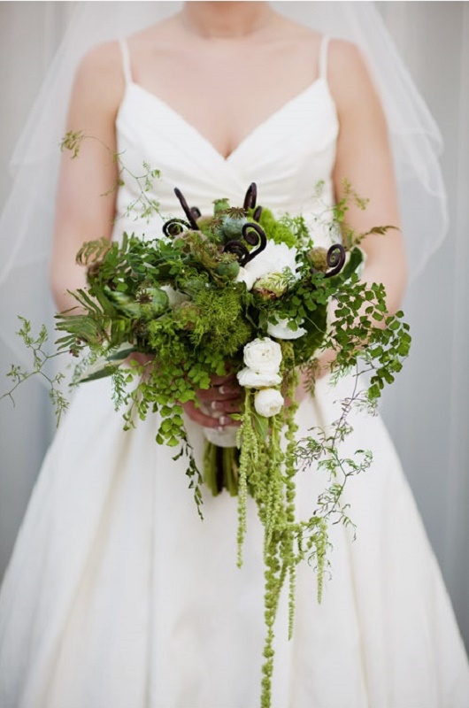 A textural greenery wedding bouquet with cascading touches, white blooms, some lotus and other stuff
