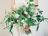 a lush textural greenery wedding bouquet with soem white and pink blooms for a more eye-catching look