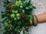 a cascading greenery wedding bouquet with lush leaves, berries and seed pods is a cool idea for a spring or summer wedding