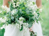 a very lush and textural greenery wedding bouquet with lots of greenery, succulents and white flowers is a cool and fresh idea