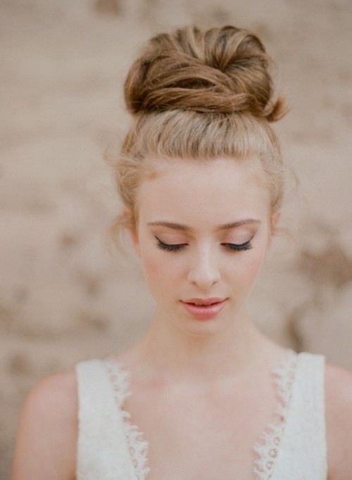 a low updo with a large bun on top and some locks down is a cute and simple hairstyle to realize yourself