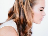 a wedding half updo with a braided halo and some waves down is a beautiful and stylish idea for many bridal looks and it will be picture-perfect for a long time
