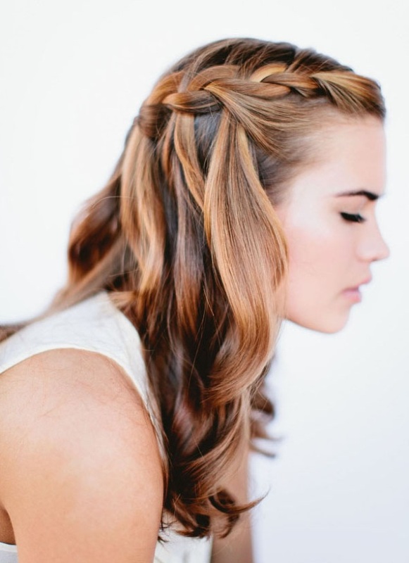 A wedding half updo with a braided halo and some waves down is a beautiful and stylish idea for many bridal looks and it will be picture perfect for a long time