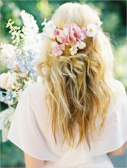 a romantic wavy and textural half updo with fresh blooms as a halo is a lovely idea for a destination wedding