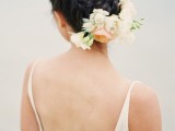 a braided low updo with neutral blooms attached is a beautiful idea for a neutral and delicate bridal look