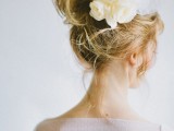 a messy wedding updo with a bit of waves and some fresh and faux blooms on top plus some locks down is a veyr cute idea for a wedding