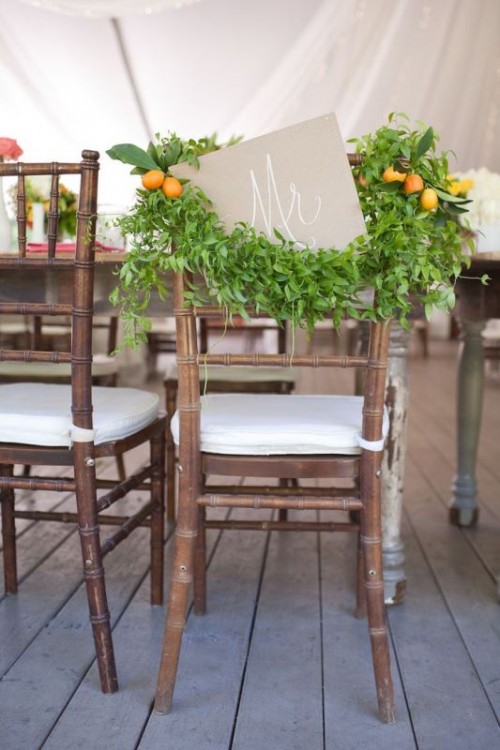 a greenery posie with kumquats and a sign is a lovely way to accent your chair, it's unusual and looks very fresh