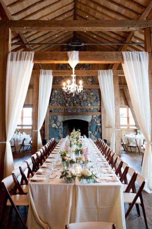 a single crystal chandelier lights up the space and makes it chic and more elegant adding to its rustic style