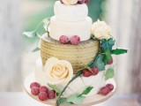 a cheese wheel wedding cake with fresh neutral blooms, berries and greenery is a lovely alternative to a usual wedding cake