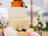 a pretty cheese wheel wedding cake topped with figs and with fresh neutral and pink blooms is a lovely idea for a spring wedding