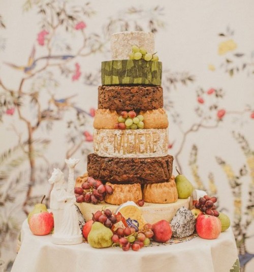 a cheese wheel wedding cake topped with fresh grapes is a lovely idea for a wedding, it can be rocked in any season and in any time