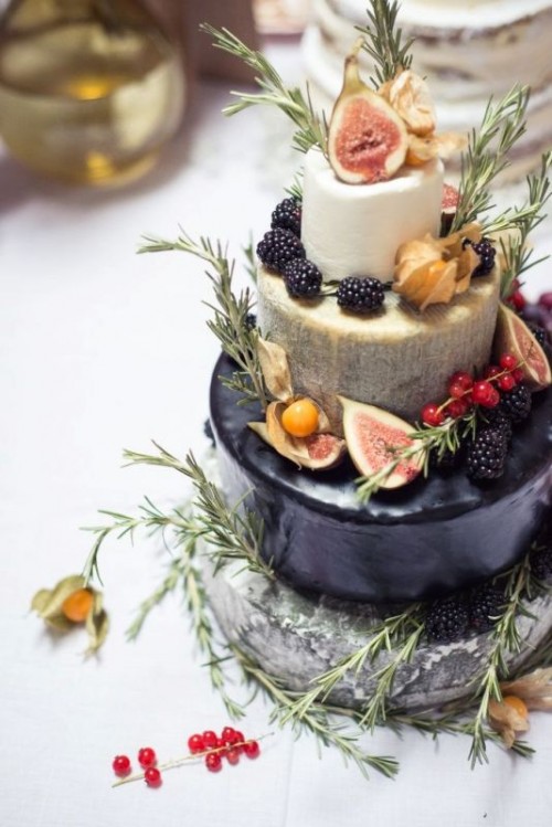 a usual glazed and cheese wheel wedding cake merged into one and topped with fresh fruit and herbs is a very creative and cool idea
