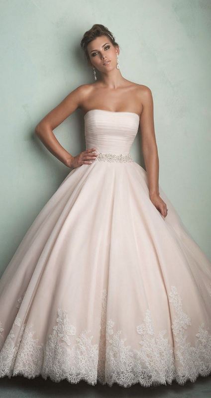 a vintage inspired strapless wedding ballgown with a draped bodice and a pleated skirt with a lace rim for a formal wedding