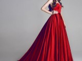 a red strapless wedding ballgown with a draped bodice and a pleated skirt with a train makes a statement with color and design