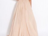 a blush A-line wedding dress with an embellished bodice, short sleeves, a cutout back and a pleated skirt with a train