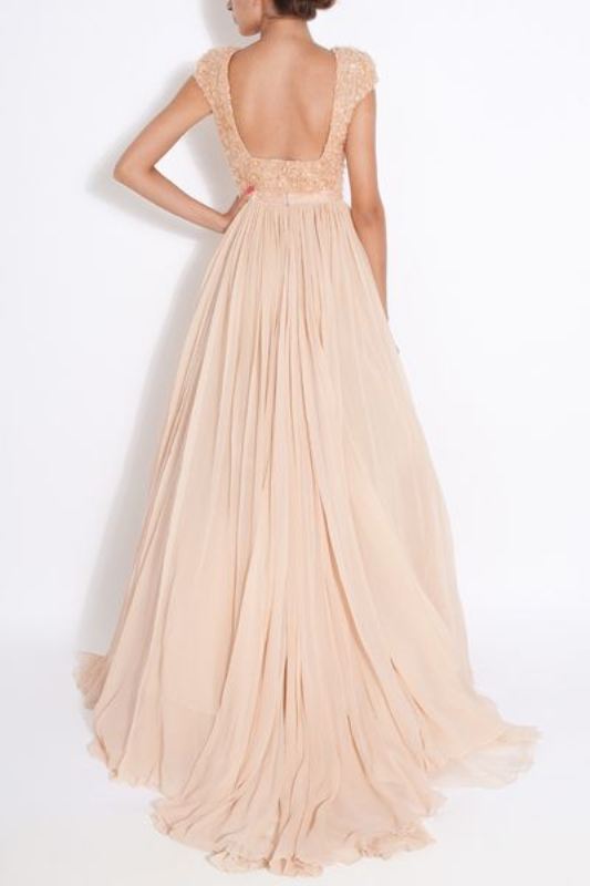 A blush A line wedding dress with an embellished bodice, short sleeves, a cutout back and a pleated skirt with a train