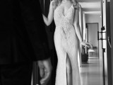 a refined and sexy sheath lace wedding dress with a plunging neckline and a front slit