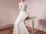 a romantic lace sheath wedding dress with a plunging neckline, long sleeves and an embellished sash