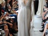 a flowy and airy wedding dress with a draped bodice, long sleeves and a plunging neckline