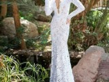 a lace sheath wedding dress with a plunging neckline and long sleeves is very sexy