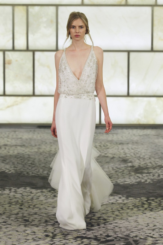 A chic loose wedding dress with an embellished bodice and a layered plain skirt plus a plunging neckline